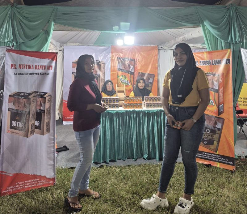 Tim PR  sedang mempromosikan Rokok produksinya di stand Festival Tembakau Madura 2025. Kehadiran mereka menarik perhatian pengunjung dan menegaskan identitas serta kualitas kretek lokal Madura