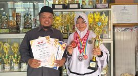 AZ Syahra Nastiti Ramadhani didampingi Kepsek Muhlisari S.Pd menunjukkan piagam dan piala prestasi setelah meraih juara 2 Mapel Matematika se-Madura dalam Lomba Matematika GCO 2026, membuktikan kerja keras dan dedikasinya dalam mengembangkan potensi akademik.