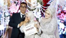 Ket Foto: Penerima hadiah paket umrah menangis haru saat nomor undiannya dibacakan langsung oleh H. Bambang Budianto. Momen penuh haru tersebut diapit kedua mempelai, H. Bambang Budianto dan Hj. Dian Mariana, dalam resepsi pernikahan di Banyuwangi.